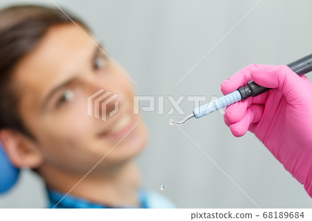 Doctor wearing pink gloves is holding ultrasonic 68189684