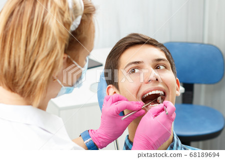 Handsome young man in visit at the dental office. 68189694