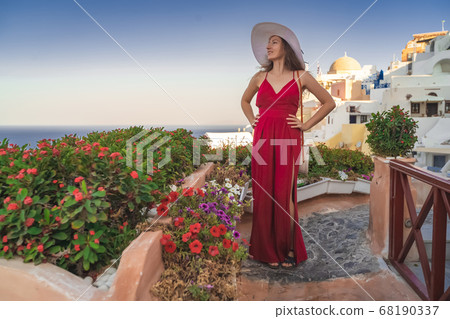 Europe Greece Santorini travel vacation woman on famous santorini Oia island travel destination. Happy young tourist woman. Summer wanderlust. Europe Greece Santorini travel vacation woman on famous santorini Oia island travel destination. Happy young tourist woman. Summer wanderlust. 68190337