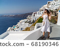 Europe Greece Santorini travel vacation woman on famous santorini Oia island travel destination. Happy young tourist woman. Summer wanderlust. 68190346