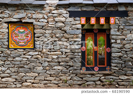 Colorful Tibetan window on the rock wall in Tibet, China 68190590