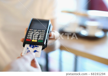 Guy waiter cafe holds terminal for payment Guy waiter cafe holds terminal for payment 68191294