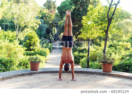 Fitness man exercising handstand in the park. Street workout 68195224