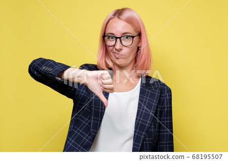 Young businesswoman in suit and glasses showingthumb down Young businesswoman in suit and glasses showingthumb down 68195507
