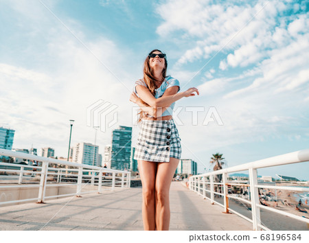 woman in sexy stylish clothes posing in the modern city with skyscrapers on background woman in sexy stylish clothes posing in the modern city with skyscrapers on background 68196584