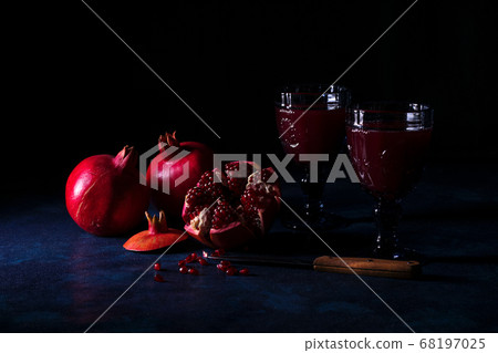 Pomegranate juice and fruits with dark background Pomegranate juice and fruits with dark background 68197025