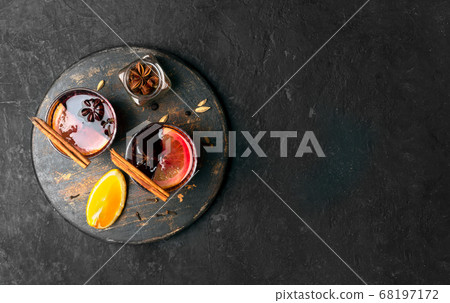Mulled wine with slice of orange and spices on a wooden background, close up 68197172