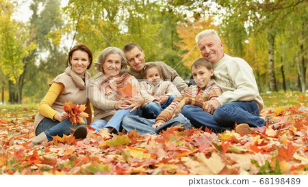 Portrait of family relaxing in autumn park Portrait of family relaxing in autumn park 68198489