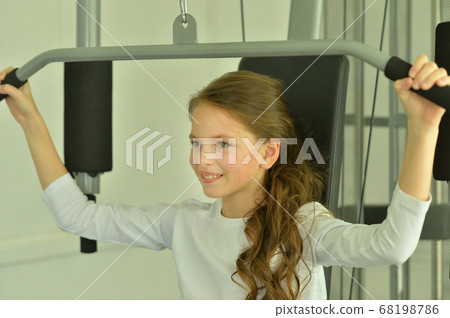 Portrait of little girl doing exercises in gym 68198786