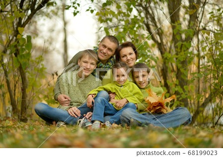 Portrait of family relaxing in autumn park Portrait of family relaxing in autumn park 68199023