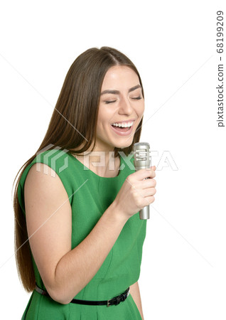 Happy young woman with microphone on white background 68199209