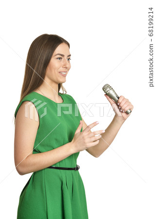 Young woman with microphone on white background Young woman with microphone on white background 68199214