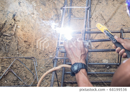 Worker welding steel structure at construction 68199536