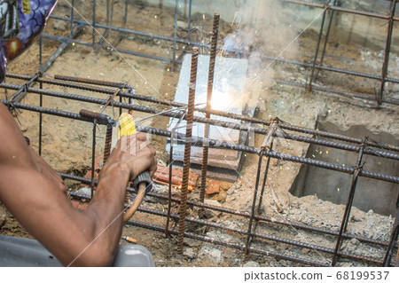 Worker welding steel structure at construction 68199537
