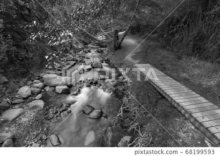 Pure water stream flowing over rocky mountain 68199593