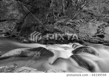 Pure water stream with smooth flow over rocky Pure water stream with smooth flow over rocky 68199594