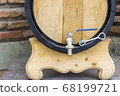 Wooden wine barrel with a tap. traditional concept of winemaking and wine tasting. 68199721