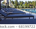 Sun beds by the pool in the open air. Pool at the spa resort. 68199722