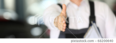 Car dealership male employee holds out his hand Car dealership male employee holds out his hand 68200640