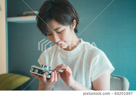 Camera girl checking camera Camera girl checking camera 68201897