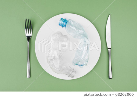 Plastic and organic garbage on the plate Plastic and organic garbage on the plate 68202000