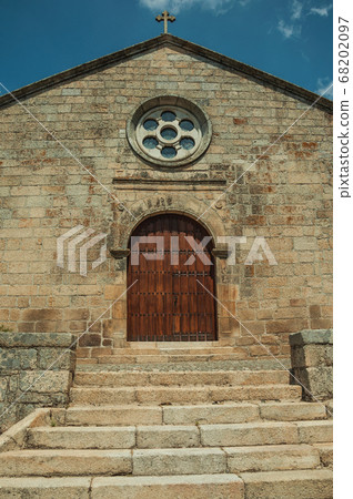 Medieval church facade with stone wall at Monsanto 68202097