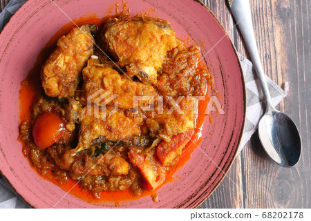 high angle view of indian fish curry on plate. high angle view of indian fish curry on plate. 68202178