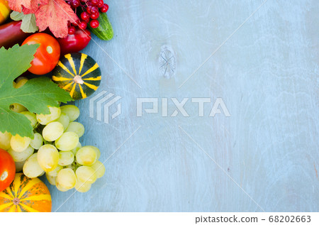 Seasonal fruits and vegetables on blue background. Autumn harvest. Seasonal fruits and vegetables on blue background. Autumn harvest. 68202663