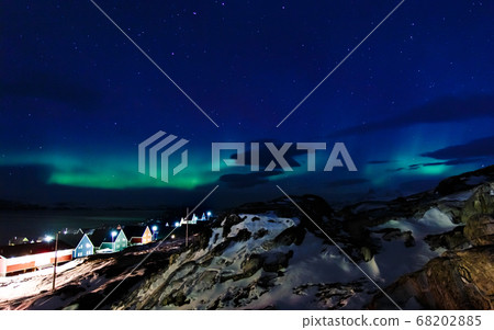 Northern lights over the Inuit village, fjord and Northern lights over the Inuit village, fjord and 68202885