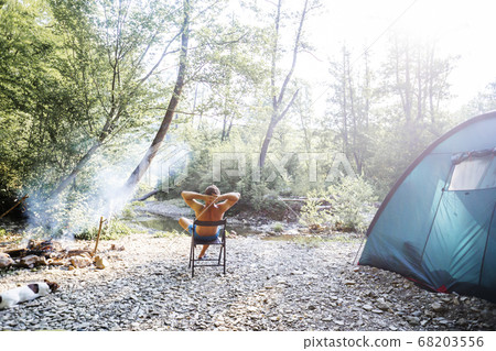 Young caucasian traveler enjoying camping. Young caucasian traveler enjoying camping. 68203556