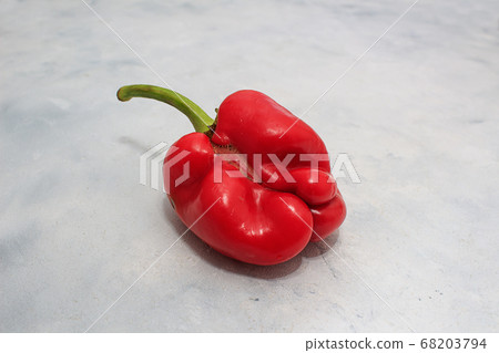 Ugly vegetables, red peppers on a gray background Ugly vegetables, red peppers on a gray background 68203794