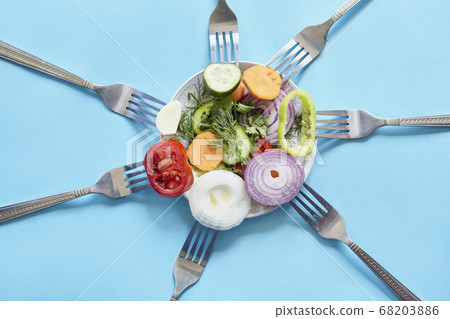 Sliced pieces of fresh vegetables on the forks Sliced pieces of fresh vegetables on the forks 68203886