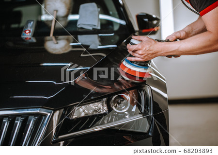 Professional detailing a car in car studio, hands with orbital polisher, scratching remover, vehicle care concept Professional detailing a car in car studio, hands with orbital polisher, scratching remover, vehicle care concept 68203893