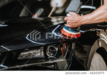 Professional detailing a car in car studio, hands with orbital polisher, scratching remover, vehicle care concept Professional detailing a car in car studio, hands with orbital polisher, scratching remover, vehicle care concept 68203975
