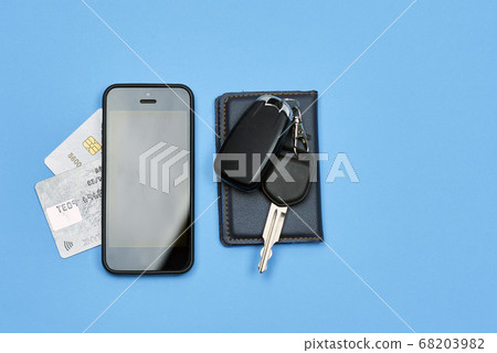 Car keys, mobile phone and credit cards on blue Car keys, mobile phone and credit cards on blue 68203982