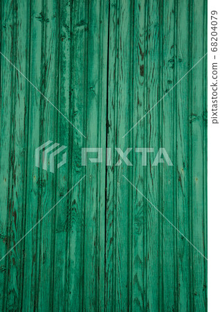 Worn planks of wood in an old green door 68204079