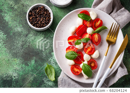 Caprese salad with tomatoes and mozzarella Caprese salad with tomatoes and mozzarella 68204124