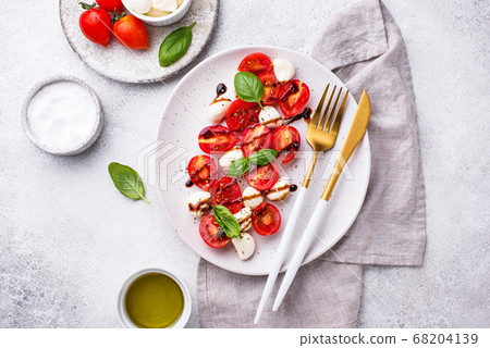 Caprese salad with tomatoes and mozzarella Caprese salad with tomatoes and mozzarella 68204139