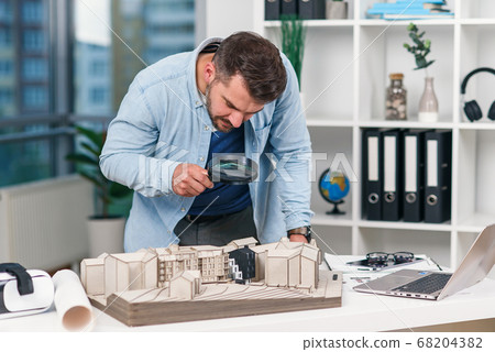 Architect Male Inspector Examines A House Model Stock Photo 68204382 Pixta