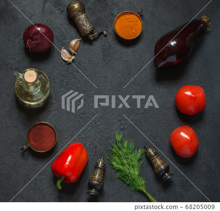 Fresh vegetables and spices on a black background in a circular layout, top view Fresh vegetables and spices on a black background in a circular layout, top view 68205009