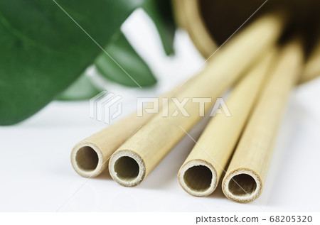 Close up bamboo straws with green leaf. Close up bamboo straws with green leaf. 68205320