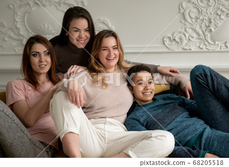 Group of young female friends hanging out at home. friendship, beauty, body positive and people concept Group of young female friends hanging out at home. friendship, beauty, body positive and people concept 68205518