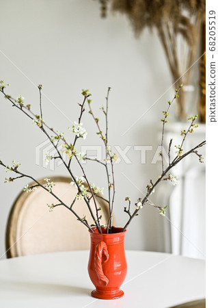cherry blossoms in a red vase. Modern interior cherry blossoms in a red vase. Modern interior 68205519