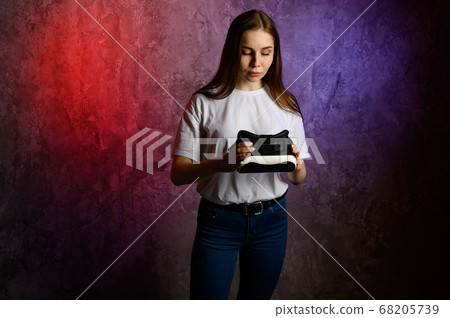 Happy young woman using a virtual reality headset 68205739