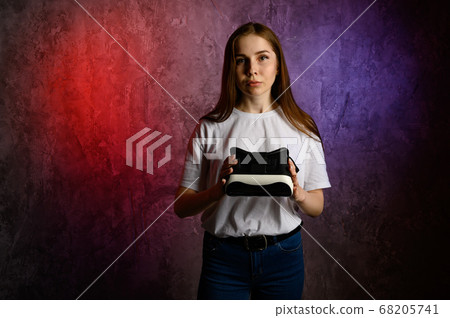 Happy young woman using a virtual reality headset 68205741