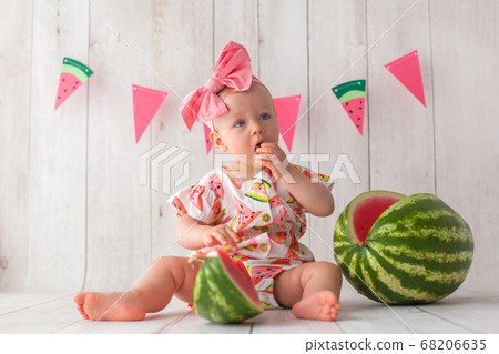 One year old baby girl eats watermelon. One year old baby girl eats watermelon. 68206635