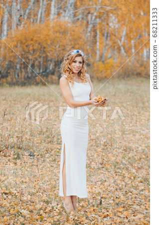 beautiful girl in a white dress in the autumn forest. nature walk. getting energy from the sun, trees. fairitale scene of a woman laying in the forest beautiful girl in a white dress in the autumn forest. nature walk. getting energy from the sun, trees. fairitale scene of a woman laying in the forest 68211333