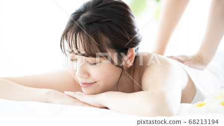 A young woman receiving a massage A young woman receiving a massage 68213194