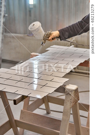 Painting furniture in a spray booth. Furniture manufacturing 68213279