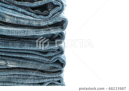 stack of jeans folded on white background 68213987